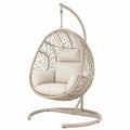 Fauteuil suspendu en métal et résine tressée beige, style bohème, dimensions 105x105x195 cm, par Aqvirel